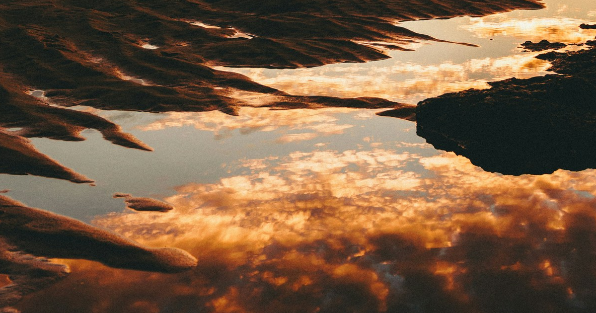 Dusk clouds reflected in still water